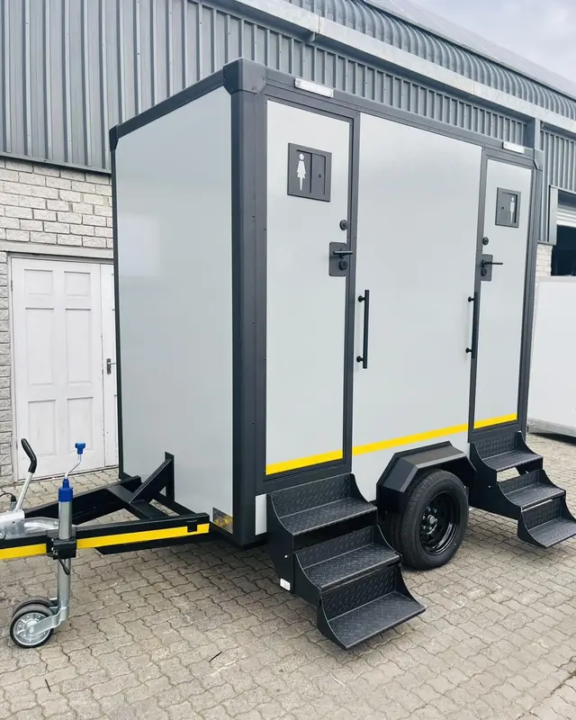 Two-stall restroom trailer with steps and separate doors